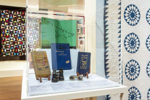 Photo of a display case in an art gallery showing books.