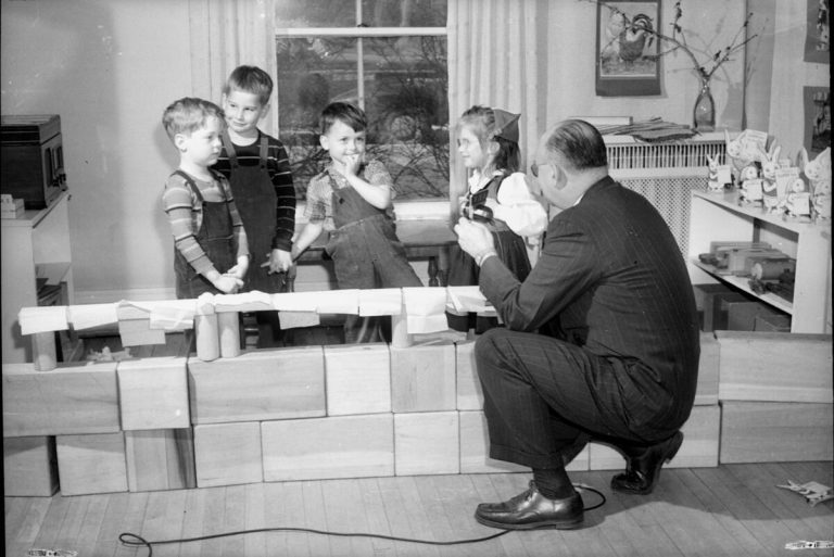 Man talking with four children at the University of Wisconsin-Madison, Home Economics School, Child Development nursery school on Linden Drive."